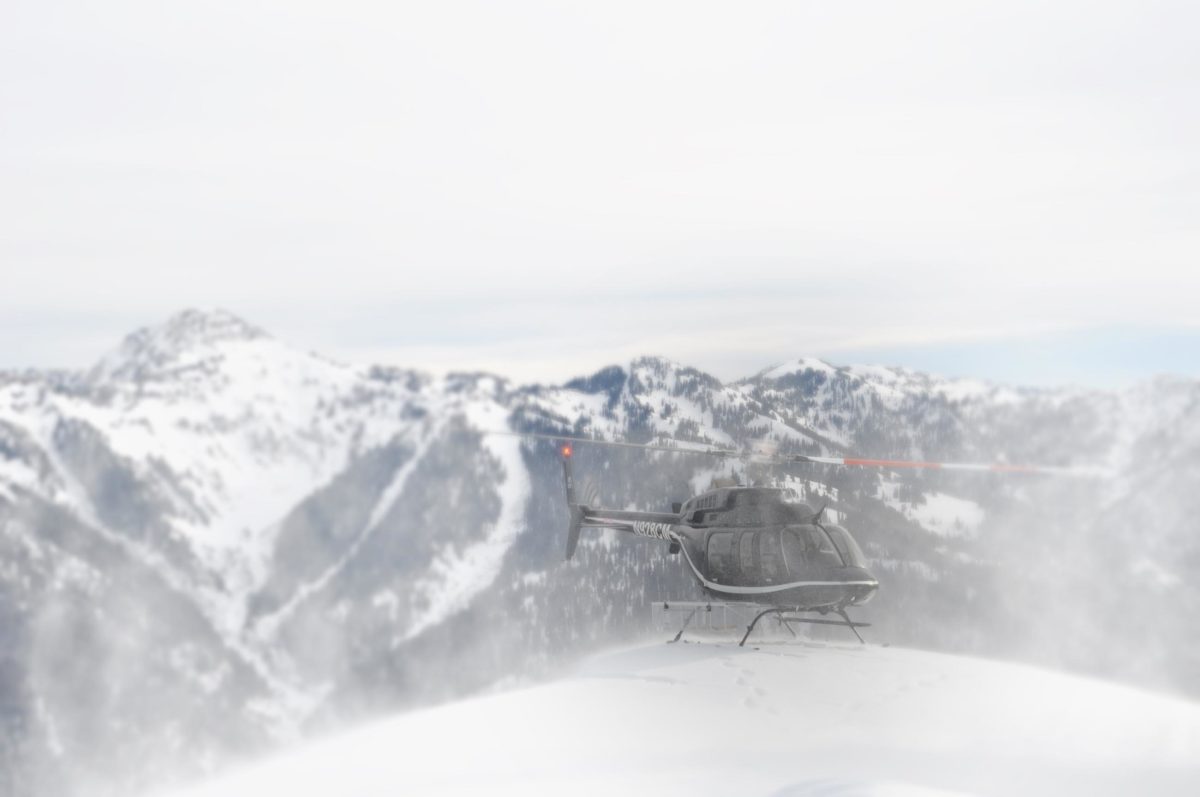 helicopter landing in snowy mountains
