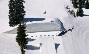 helicopter filming skiier in snow