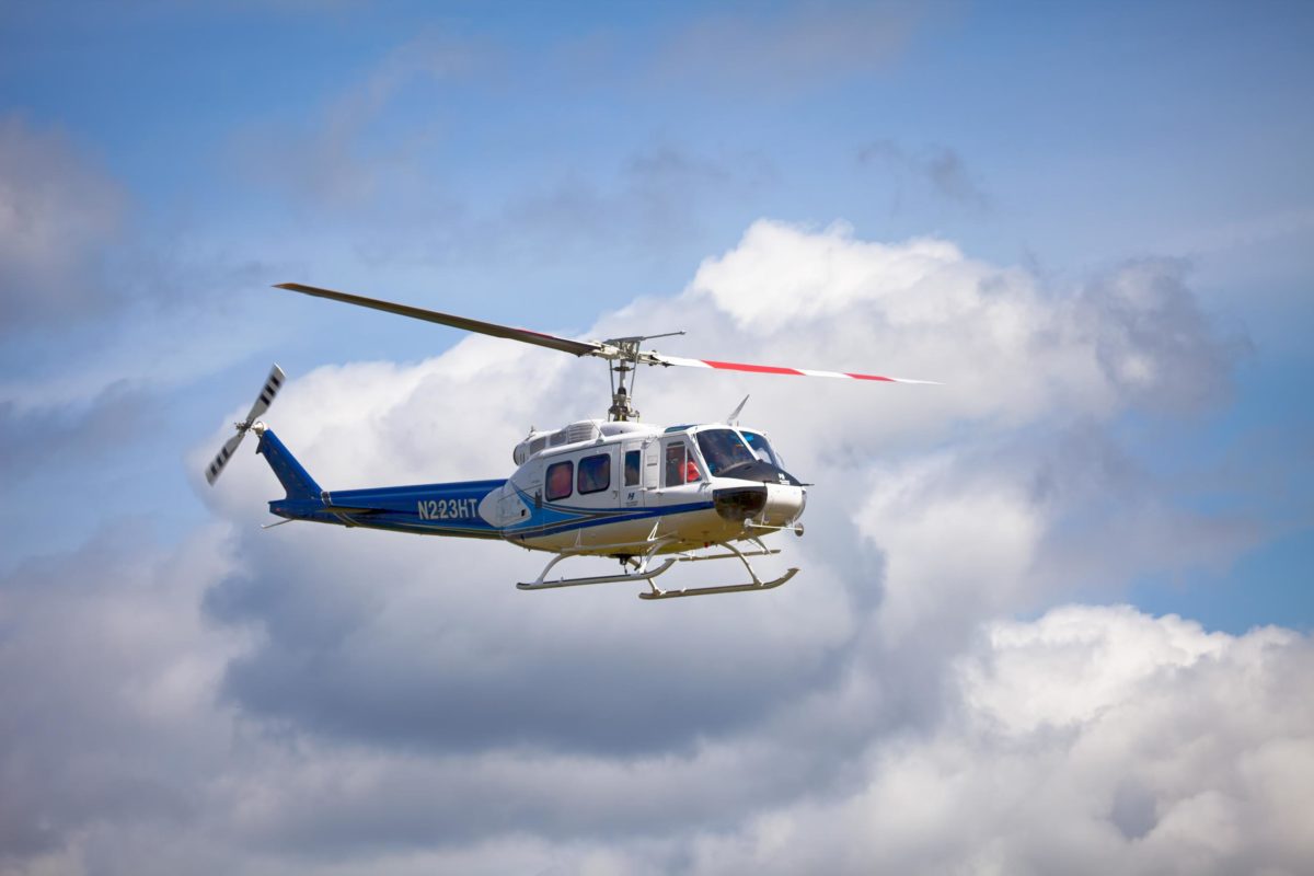helicopter flying with cloud backdrop