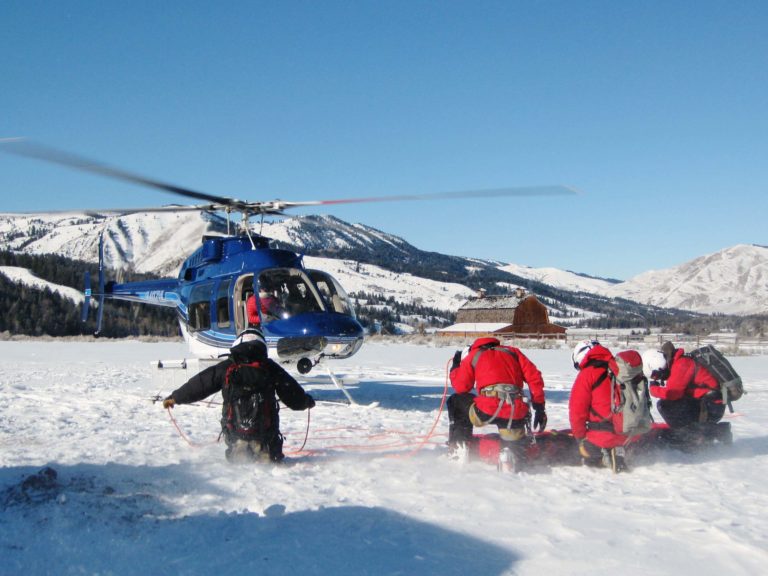 rescue crew and helicopter in snow