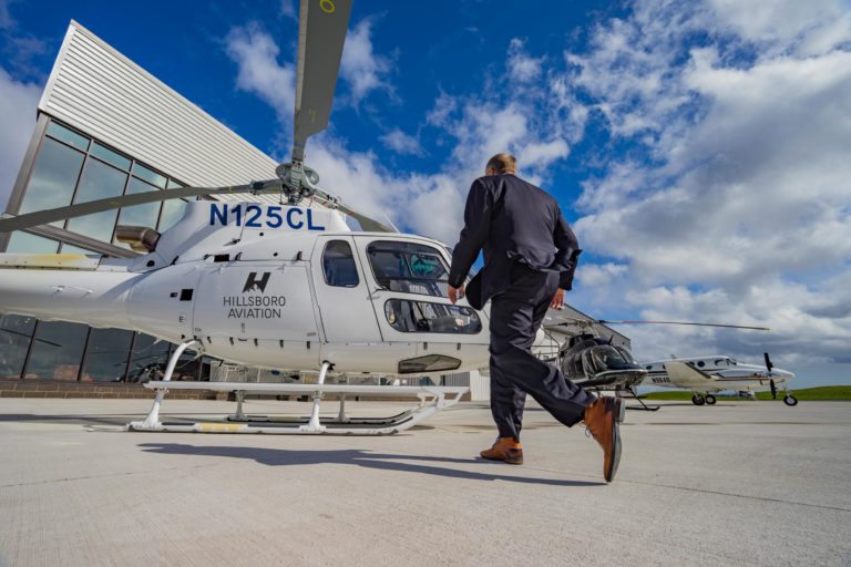 man walking to airbus h125 helicopter